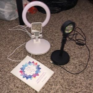 Used ring light phone holder and light projector and a book